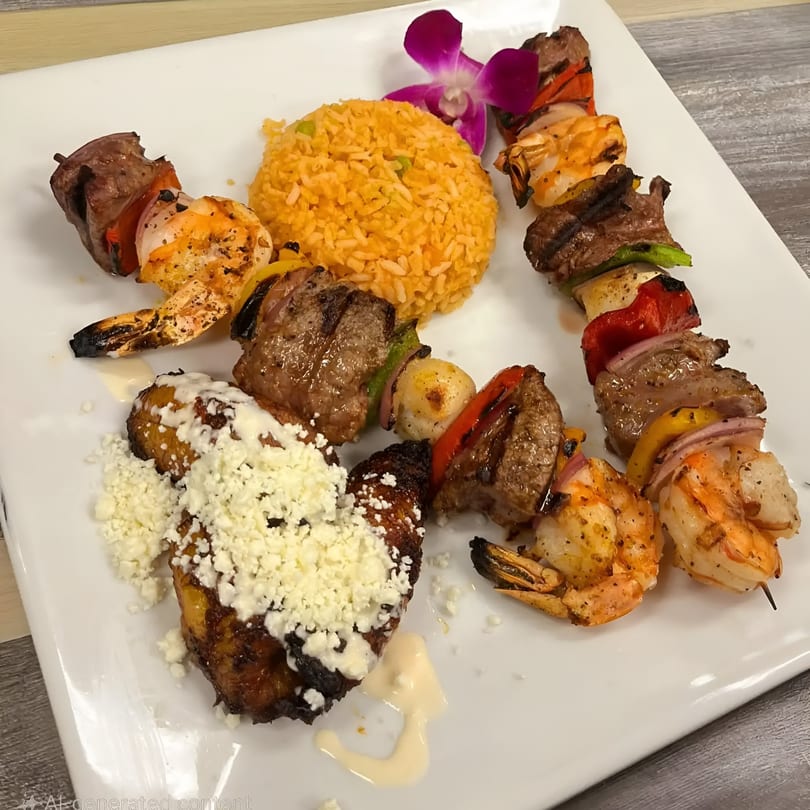 Grilled shrimp and beef skewers with rice, plantains, and a purple orchid on a white plate.
